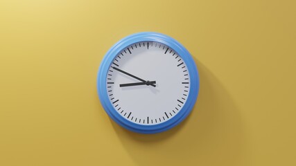 Glossy blue clock on a orange wall at forty-nine past eight. Time is 08:49 or 20:49