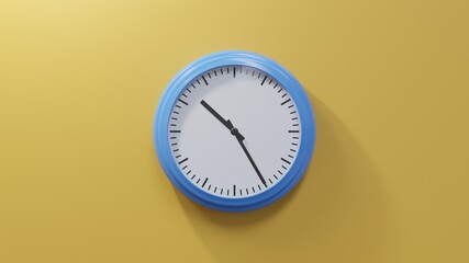 Glossy blue clock on a orange wall at twenty-five past ten. Time is 10:25 or 22:25