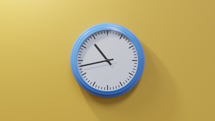 Glossy blue clock on a orange wall at forty-three past ten. Time is 10:43 or 22:43