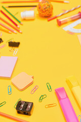 Back to school concept, school supplies on yellow background, university, college, copy space