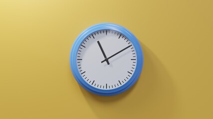 Glossy blue clock on a orange wall at ten past eleven. Time is 11:10 or 23:10