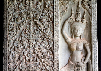 Beautiful bas-relief in Angkor wat temple in Cambodia, representing dancing apsara -  female spirit popular in 12th century Cambodia.