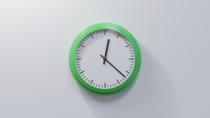 Glossy green clock on a white wall at twenty-two past twelve. Time is 00:22 or 12:22
