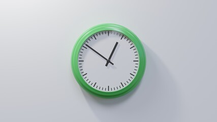 Glossy green clock on a white wall at fifty-one past twelve. Time is 00:51 or 12:51