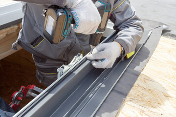 Professional worker fix the window frame for mansard room