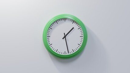 Glossy green clock on a white wall at twenty-eight past one. Time is 01:28 or 13:28