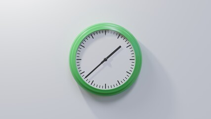 Glossy green clock on a white wall at thirty-eight past one. Time is 01:38 or 13:38