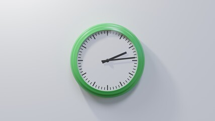 Glossy green clock on a white wall at fourteen past two. Time is 02:14 or 14:14