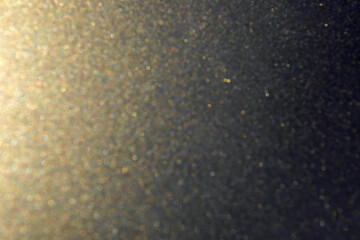 Gold and black glitter light defocused background, abstract shine pattern background
