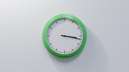 Glossy green clock on a white wall at seventeen past three. Time is 03:17 or 15:17