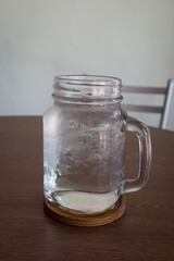 Summer cocktail with ice cubes on wooden table