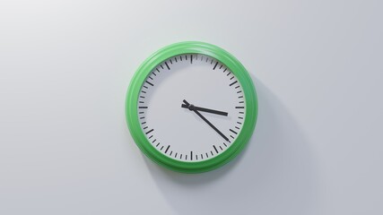 Glossy green clock on a white wall at twenty-two past three. Time is 03:22 or 15:22