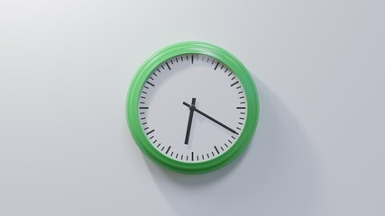 Glossy green clock on a white wall at twenty past six. Time is 06:20 or 18:20