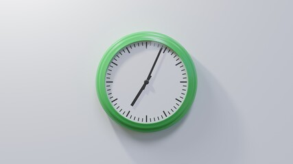 Glossy green clock on a white wall at four past seven. Time is 07:04 or 19:04