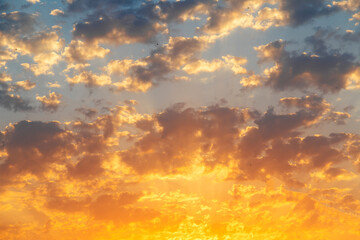 Beautiful colorful sunset sky with orange clouds. Nature sky background. Dramatic sunset.