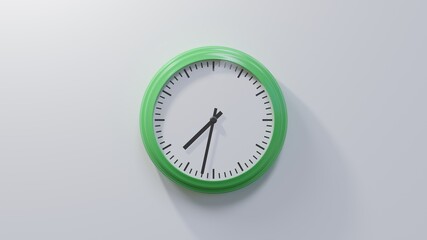 Glossy green clock on a white wall at thirty-two past seven. Time is 07:32 or 19:32