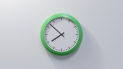 Glossy green clock on a white wall at fifty-two past seven. Time is 07:52 or 19:52