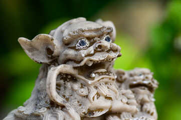 Old Chinese lion statuette in the temple