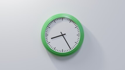 Glossy green clock on a white wall at twenty-five past eight. Time is 08:25 or 20:25