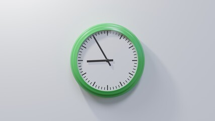 Glossy green clock on a white wall at five to nine. Time is 08:55 or 20:55