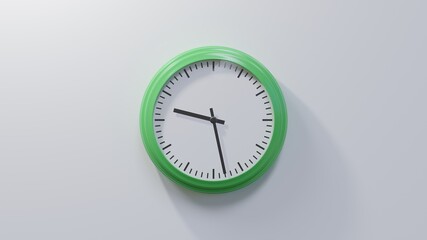 Glossy green clock on a white wall at twenty-eight past nine. Time is 09:28 or 21:28