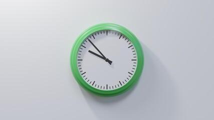 Glossy green clock on a white wall at fifty-three past nine. Time is 09:53 or 21:53
