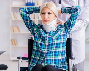 Disabled woman in wheel chair visiting man doctor