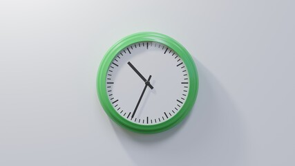 Glossy green clock on a white wall at thirty-four past ten. Time is 10:34 or 22:34