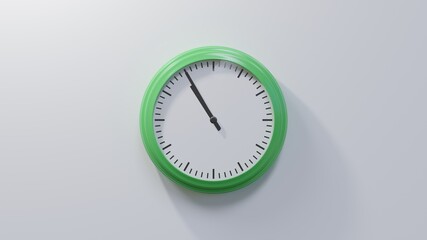 Glossy green clock on a white wall at five to eleven. Time is 10:55 or 22:55