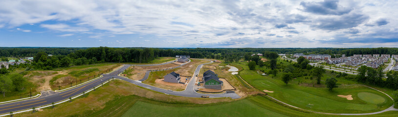 Aerial view of new luxury single family home community in the middle of a golf course in Maryland