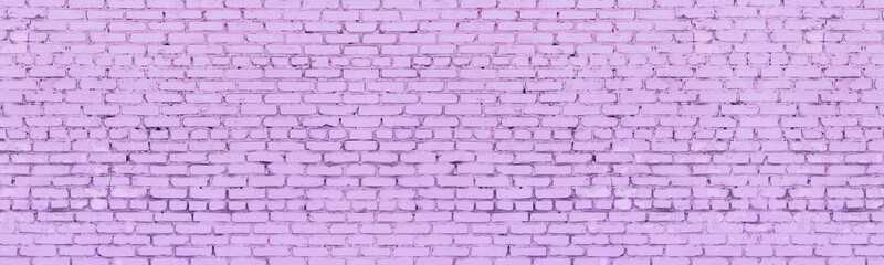 Bright lavender color painted shabby old brick wall wide texture. Light pastel purple rough brickwork widescreen background