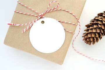Blank round Christmas gift tag mockup, product label mockup,  gift box, top view.