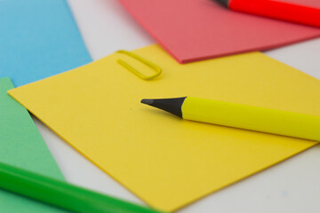 colored stickers note paper and pencil on a white background