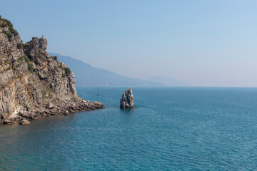 Rock Sail, Yalta, southern coast of Crimea. Calm blue sea and clear sky on the background. Summer vacation concept