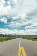 An empty highway road under cloudy sky