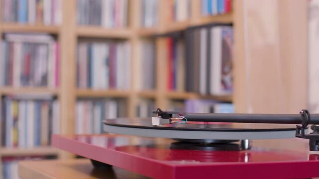 Stopping a black vinyl lp on a record player close up