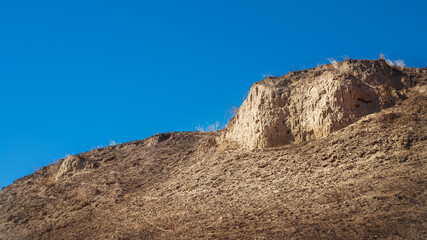 Clay mountain against the blue sky.
