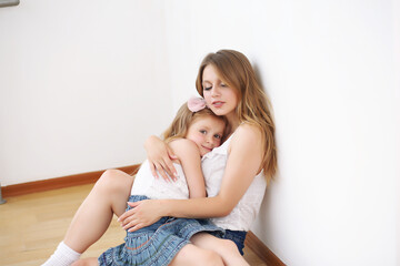 Naklejka na ściany i meble Lifestyle portrait of mom and daughter in happy home