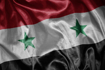 colorful shining big national flag of syria on a silky texture