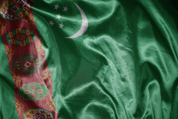 colorful shining big national flag of turkmenistan on a silky texture