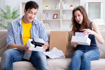 Young family playing games with virtual reality glasses