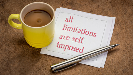 all limitations are self imposed inspirational note - writing on a napkin with a cup of coffee, business or personal development concept