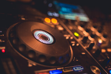 DJ Spinning, Mixing, and Scratching in a Night Club. DJ playing music at mixer . Closeup. Party.