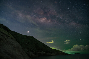 Obraz na płótnie Canvas Long exposure Night Photography with Milky way over sea in phuket thailand.