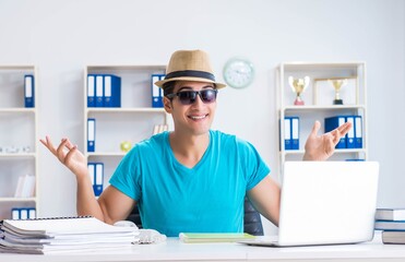 Businessman preparing for vacation in the office