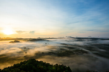 Fototapeta premium Beautiful sunrise with sea of misty in dawn morning on the top of Khao Na Nai Luang Temple Park, Surat Thani province,Thailand