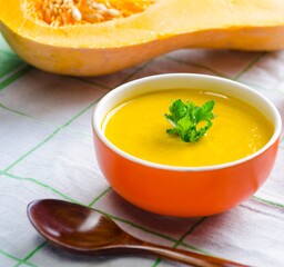 Pumpkin soup served on the table in bowl