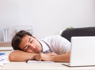 Young handsome businessman working in office