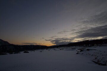 sunset in snowed rice field on the mountains, Japan