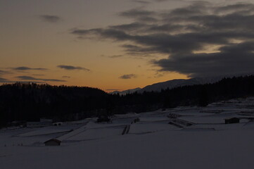 sunset in snowed rice field on the mountains, Japan